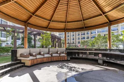 a couch sitting under a pavilion in a building at Superb Amenities - 1BR in Resortz by Danube,Arjan - Allsopp&Allsopp in Dubai