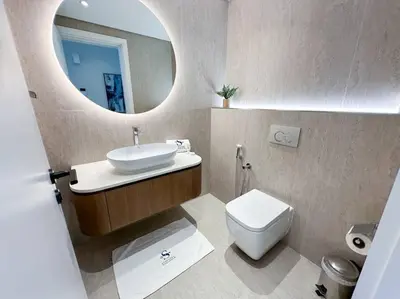 a bathroom with a sink and a toilet and a mirror at Fantastic flat in TiaraResidence in Dubai