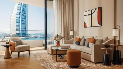 a living room with a couch and a table at Jumeirah Residences Marsa Al Arab Dubai in Dubai