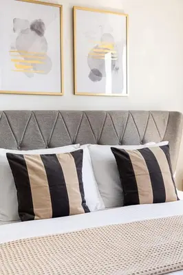 a bed with black and white pillows in a bedroom at Frank Porter - Goldcrest Views 2 in Dubai