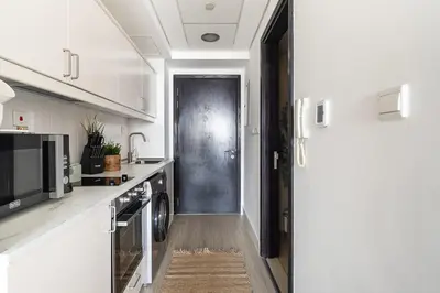 a kitchen with a door leading to a kitchen with a stove at Frank Porter - Goldcrest Views 2 in Dubai