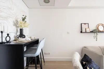 a living room with a table and a couch at Frank Porter - Goldcrest Views 2 in Dubai