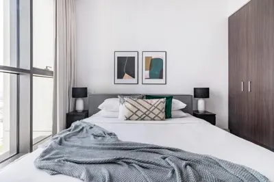 a bedroom with a bed with a blanket on it at GuestReady - Modern home with stunning city views in Dubai
