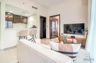 a living room with a couch and a tv at Graceful 1BR at Merano Business Bay by Deluxe Holiday Homes in Dubai