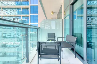 a table and chairs on the balcony of a building at Graceful 1BR at Merano Business Bay by Deluxe Holiday Homes in Dubai