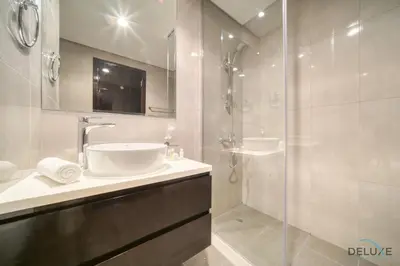 a bathroom with a sink and a shower at Graceful 1BR at Merano Business Bay by Deluxe Holiday Homes in Dubai