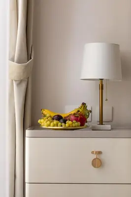 a plate of fruit on a dresser next to a lamp at Happy ACADEMIA JBR in Dubai
