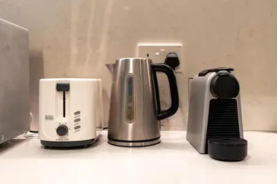 a group of appliances sitting on top of a counter at Stylish 1BR Apartment in La Mer Dubai with Balcony and Partial Marina Views in Dubai