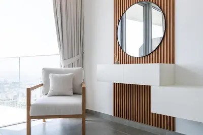 a mirror and a chair in a room with a window at Urban tropic 3 bedroom apartment with full sea view by Suiteable Interiors in Dubai