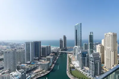 an aerial view of a city with a river and buildings at Urban tropic 3 bedroom apartment with full sea view by Suiteable Interiors in Dubai
