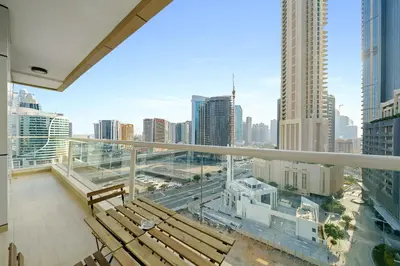 a balcony with benches and a view of a city at Bright & Vibrant 2BR+kids room 7min to Dubai Mall in Dubai