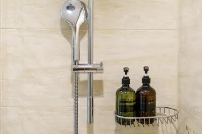 a spoon and two bottles of wine on a shelf at Bright & Vibrant 2BR+kids room 7min to Dubai Mall in Dubai
