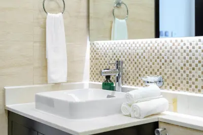 a bathroom with a white sink and a mirror at Bright & Vibrant 2BR+kids room 7min to Dubai Mall in Dubai