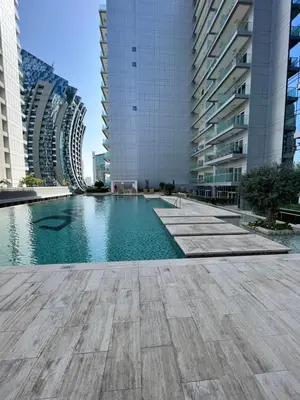 a swimming pool in a city with tall buildings at Majestine Apartments in Dubai