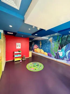 a childrens room with a purple floor and an aquarium at Majestine Apartments in Dubai