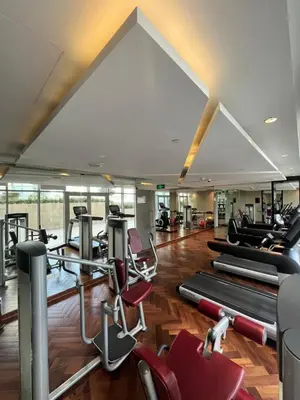 a gym with pilates equipment in a building at Majestine Apartments in Dubai