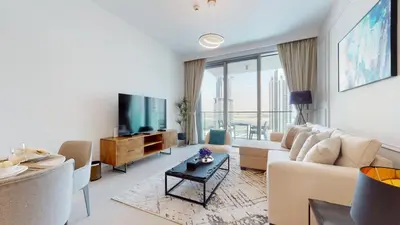 a living room with a couch and a tv at Luxury 1 Bedroom Sea View and Infinity Pool in Dubai