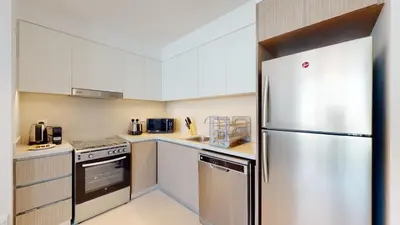 a kitchen with a stainless steel refrigerator at Luxury 1 Bedroom Sea View and Infinity Pool in Dubai