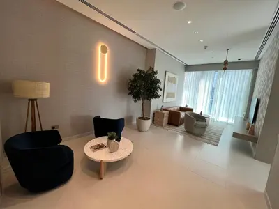 a living room with chairs and a table and a couch at Luxury 1 Bedroom Sea View and Infinity Pool in Dubai