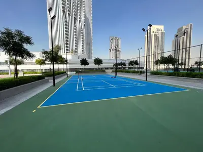 a tennis court in a city with tall buildings at Luxury 1 Bedroom Sea View and Infinity Pool in Dubai