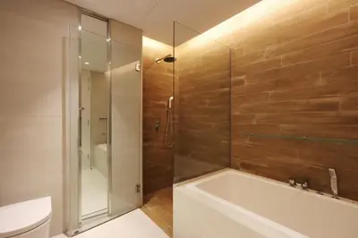 a bathroom with a shower and a tub and a toilet at High-End 1BR Bluewaters Luxury Near Ain Dubai in Dubai