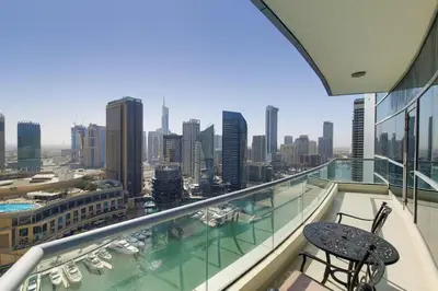 a balcony with two chairs and a view of a city at Bay Central, Dubai Marina - Peaceful One Bedroom in Dubai