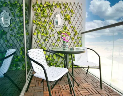 a balcony with a table and chairs on a patio at Exceptional Furnished Studio in Dubai