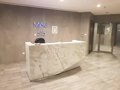 a marble counter in a lobby with a sign on the wall at Exceptional Furnished Studio in Dubai