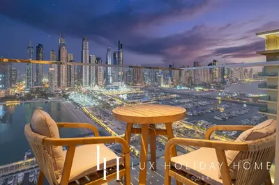 a balcony with a table and chairs and a harbor at LUX The Luxury Sunrise Beachfront Suite 1 in Dubai