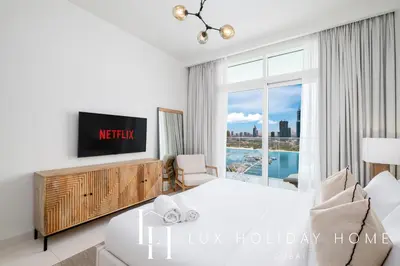 a bedroom with a bed and a large window at LUX The Luxury Sunrise Beachfront Suite 1 in Dubai