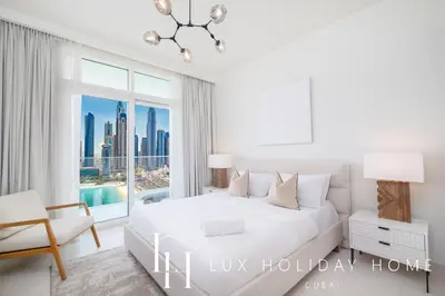 a bedroom with a bed and a large window at LUX The Luxury Sunrise Beachfront Suite 1 in Dubai