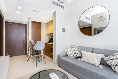 a living room with a couch and a mirror at Skyline 20thModern 1BRIconic Burj Khalifa View in Dubai