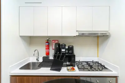 a kitchen with a sink and a stove top oven at Skyline 20thModern 1BRIconic Burj Khalifa View in Dubai