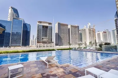 a swimming pool with a city skyline in the background at Skyline 20thModern 1BRIconic Burj Khalifa View in Dubai