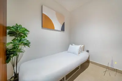 a white bench in a room with a plant at Luxurious 3BR Maid room 33rd Floor Marina Gate in Dubai