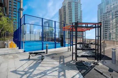 a gym with a pool in the middle of a city at Luxurious 3BR Maid room 33rd Floor Marina Gate in Dubai