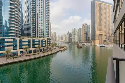 a river in the middle of a city with tall buildings at Stylish Waterfront 2 Bed in Dubai Marina in Dubai