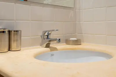 a bathroom sink with a faucet on a counter at Stylish Waterfront 2 Bed in Dubai Marina in Dubai