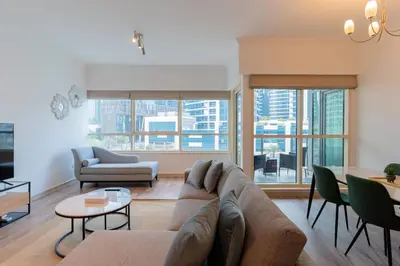 a living room with a couch and a table at Stylish Waterfront 2 Bed in Dubai Marina in Dubai