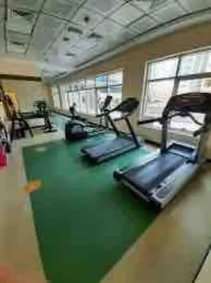 a gym with treadmills and ellipticals in a room at Amazing Largest Studio in Marina Next to Metro - Central Location in Dubai