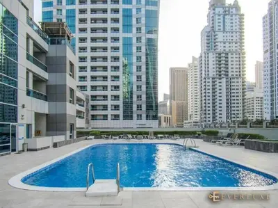 a large swimming pool in a city with tall buildings at Amazing Largest Studio in Marina Next to Metro - Central Location in Dubai