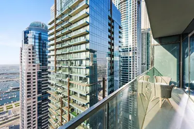 a balcony with a view of a city at StoneTree - Marina Gate 2 BR - Partial Sea View in Dubai