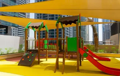 a playground with a slide and a slideintend at StoneTree - Marina Gate 2 BR - Prime location in Dubai