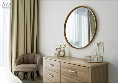 a bedroom with a mirror and a chair at Fancy One Bedroom Apartment in Downtown Dubai By ĀYA Boutique in Dubai