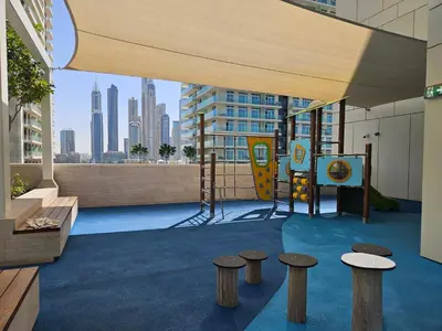 a playground in a building with a view of a city at Vacay Lettings - Private Beach Access -Emaar Beachfront in Dubai