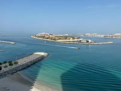 an aerial view of a body of water with an island at Vacay Lettings - Private Beach Access -Emaar Beachfront in Dubai