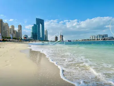 a beach with the ocean and buildings in the background at Canal View apartment in Address Beach Residence JBR, the 29th floor, 1BR in Dubai
