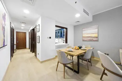 a dining room with a table and chairs at Classy Design 2BR in Old Town w/ Burj Khalifa View in Dubai