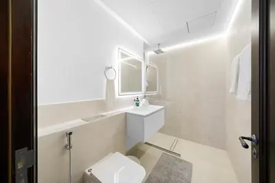 a white bathroom with a sink and a toilet at Classy Design 2BR in Old Town w/ Burj Khalifa View in Dubai