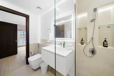 a bathroom with a toilet and a sink and a shower at Classy Design 2BR in Old Town w/ Burj Khalifa View in Dubai